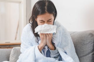 ThinkHealth personal wellness woman sneezing