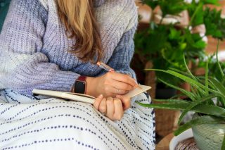 Woman writing in journal 