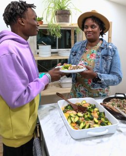 Mom handing meal to son