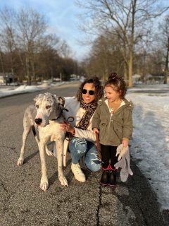 mom and daughter outside walking dog in winter