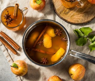 Example of simmer pot with apple cider, cinnamon sticks, citrus fruit, and star anise